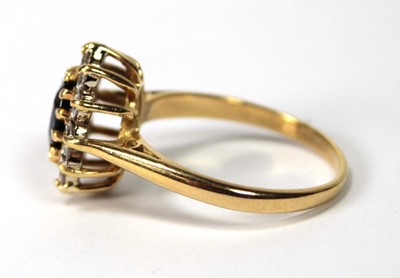Lot 530 - An 18ct yellow gold cluster ring set oval...