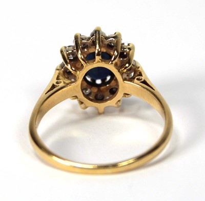 Lot 530 - An 18ct yellow gold cluster ring set oval...