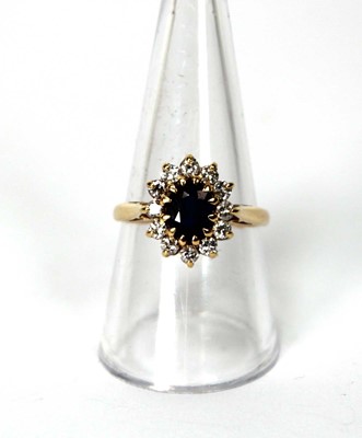 Lot 530 - An 18ct yellow gold cluster ring set oval...