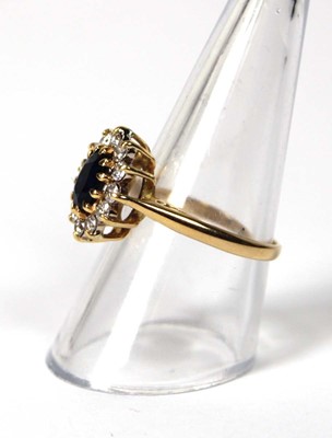 Lot 530 - An 18ct yellow gold cluster ring set oval...