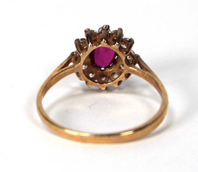 Lot 534 - A 9ct yellow gold cluster ring set ruby and...
