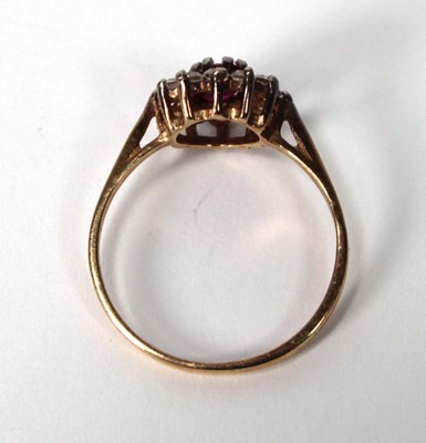 Lot 534 - A 9ct yellow gold cluster ring set ruby and...