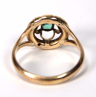 Lot 539 - A 9ct yellow gold ring set green stone in a...