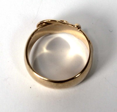 Lot 556 - A 9ct yellow gold buckle ring, London 1971,...
