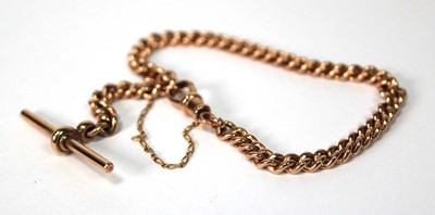 Lot 557 - A 9ct rose gold curblink bracelet with t-bar...