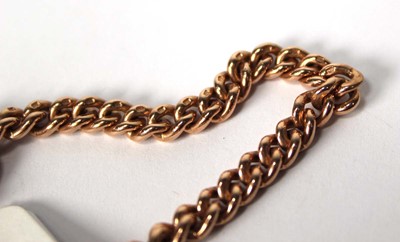 Lot 557 - A 9ct rose gold curblink bracelet with t-bar...