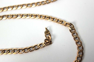 Lot 559 - A 9ct yellow gold flat curblink necklace with...