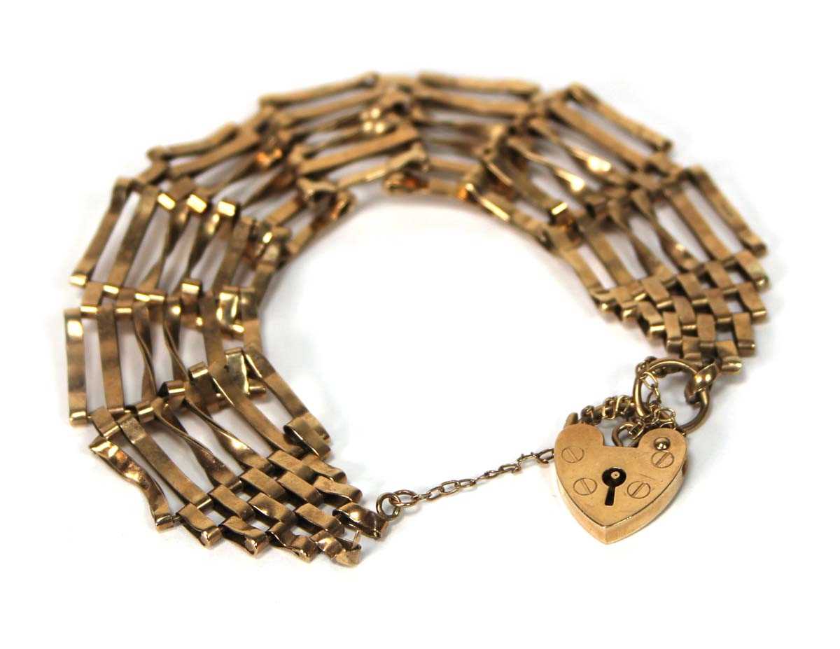 Lot 566 - A 9ct yellow gold six bar gatelink bracelet...