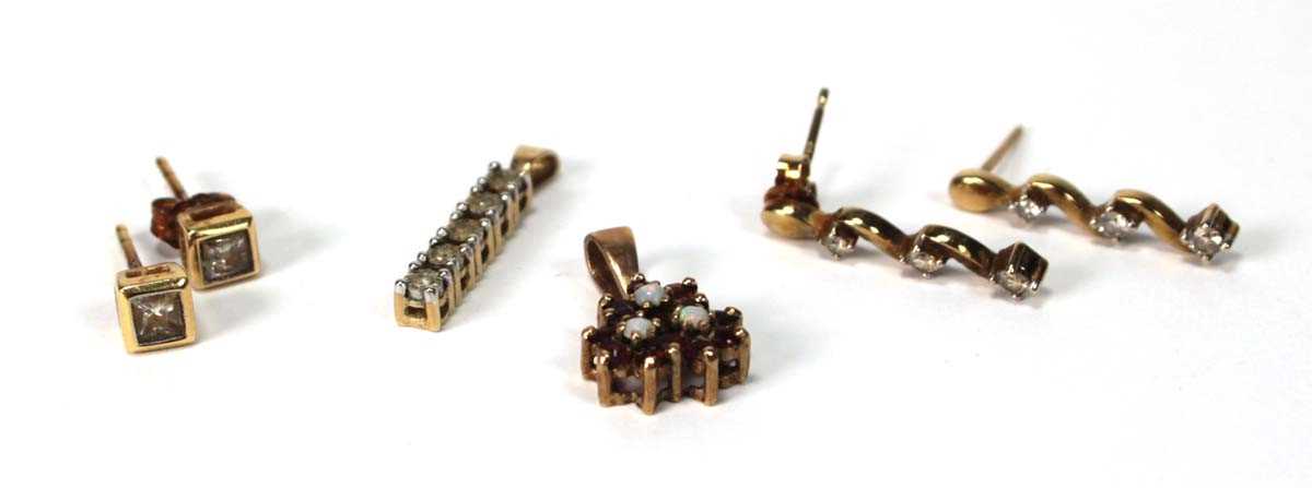 Lot 574 - A pair of 9ct yellow gold ear studs, each set...