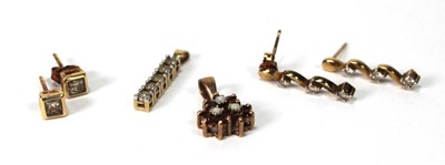 Lot 574 - A pair of 9ct yellow gold ear studs, each set...