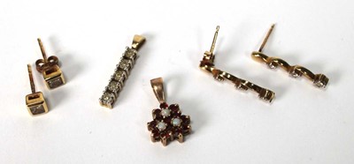 Lot 574 - A pair of 9ct yellow gold ear studs, each set...
