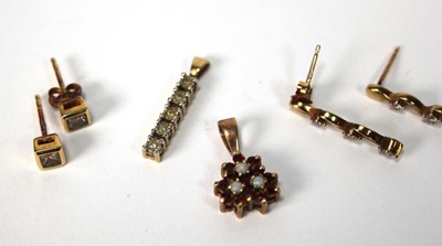 Lot 574 - A pair of 9ct yellow gold ear studs, each set...