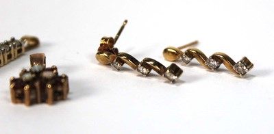 Lot 574 - A pair of 9ct yellow gold ear studs, each set...