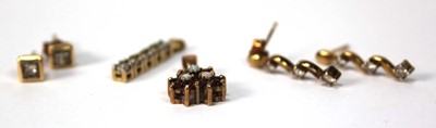 Lot 574 - A pair of 9ct yellow gold ear studs, each set...