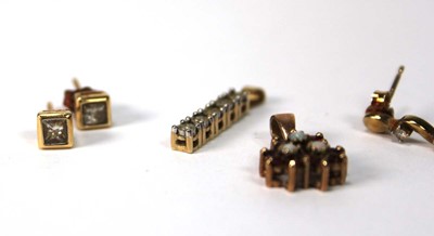 Lot 574 - A pair of 9ct yellow gold ear studs, each set...