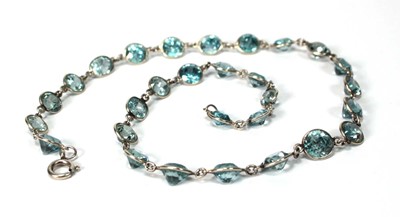 Lot 576 - A silver necklace suspending twenty-nine round...