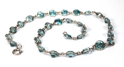 Lot 576 - A silver necklace suspending twenty-nine round...