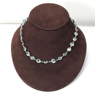 Lot 576 - A silver necklace suspending twenty-nine round...