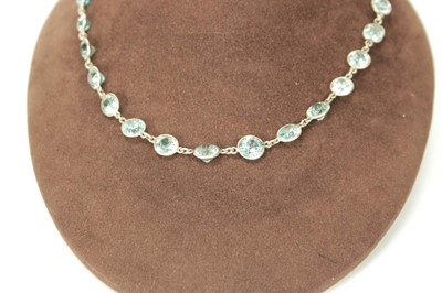 Lot 576 - A silver necklace suspending twenty-nine round...
