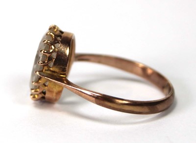 Lot 581 - A 9ct yellow gold ring set oval quartz type...