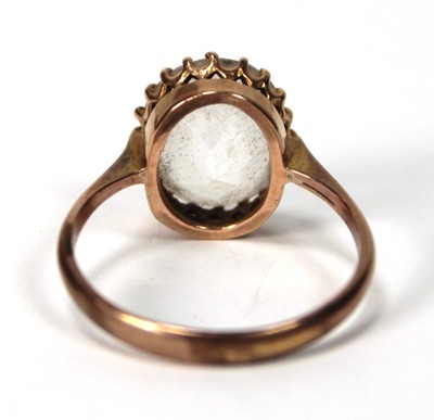 Lot 581 - A 9ct yellow gold ring set oval quartz type...