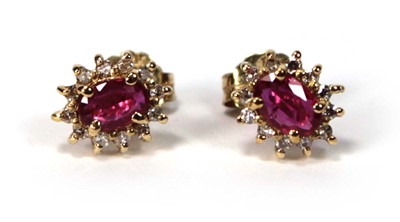 Lot 582 - A pair of 14ct yellow gold ear studs, each set...