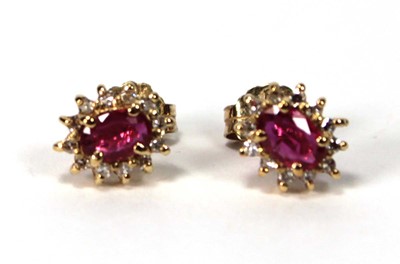 Lot 582 - A pair of 14ct yellow gold ear studs, each set...