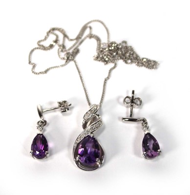 Lot 588 - A 9ct white gold pendant necklace set teardrop...