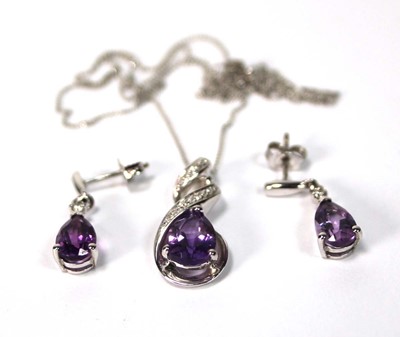 Lot 588 - A 9ct white gold pendant necklace set teardrop...