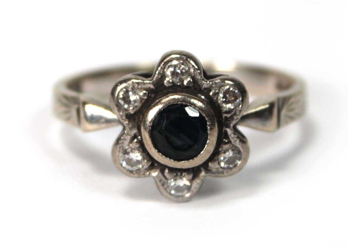 Lot 591 - An 18ct white gold cluster ring set small...
