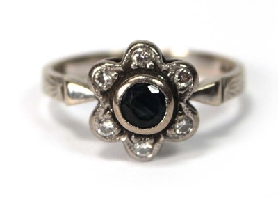 Lot 591 - An 18ct white gold cluster ring set small...