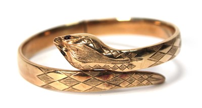Lot 594 - A 9ct yellow gold hinged bracelet of serpent...