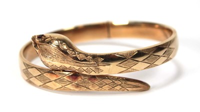 Lot 594 - A 9ct yellow gold hinged bracelet of serpent...