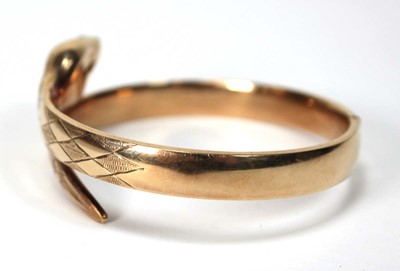 Lot 594 - A 9ct yellow gold hinged bracelet of serpent...