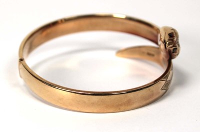 Lot 594 - A 9ct yellow gold hinged bracelet of serpent...