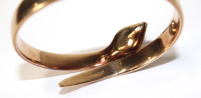 Lot 594 - A 9ct yellow gold hinged bracelet of serpent...