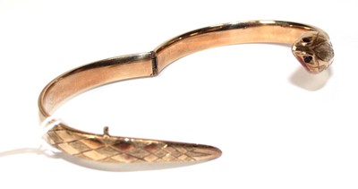 Lot 594 - A 9ct yellow gold hinged bracelet of serpent...