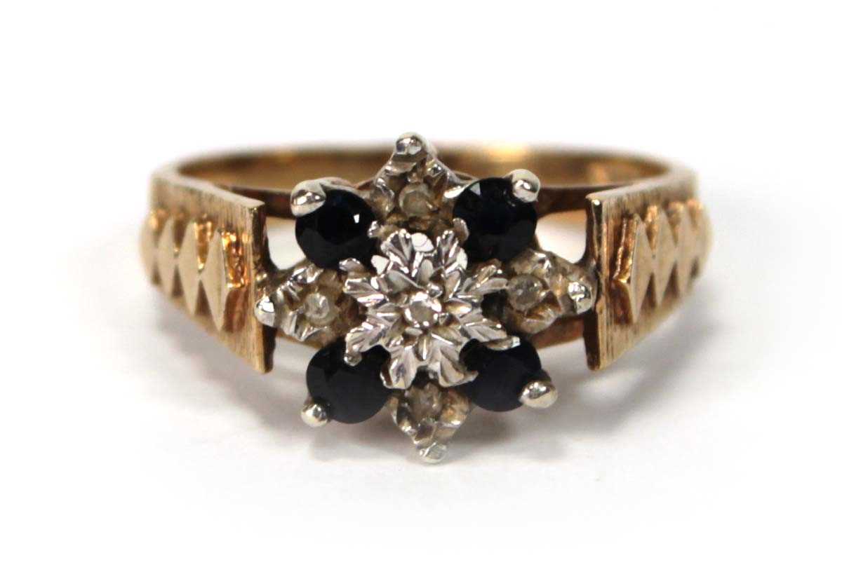 Lot 599 - A 9ct yellow gold cluster ring set four small...