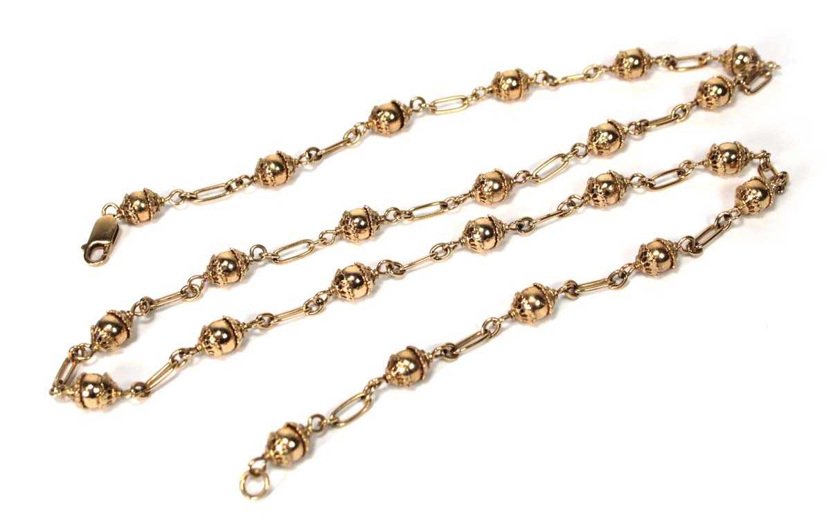 Lot 601 - A 9ct yellow gold bead necklace of Eastern...