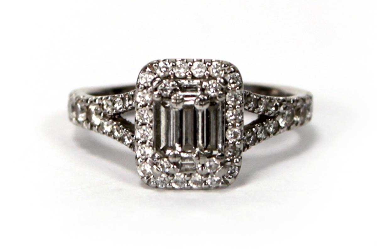 Lot 603 - A platinum halo cluster ring set baguette and...