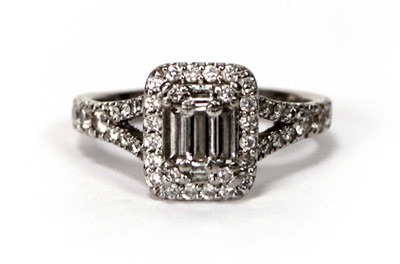 Lot 603 - A platinum halo cluster ring set baguette and...