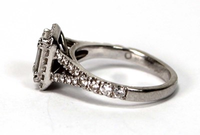 Lot 603 - A platinum halo cluster ring set baguette and...