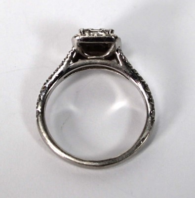 Lot 603 - A platinum halo cluster ring set baguette and...