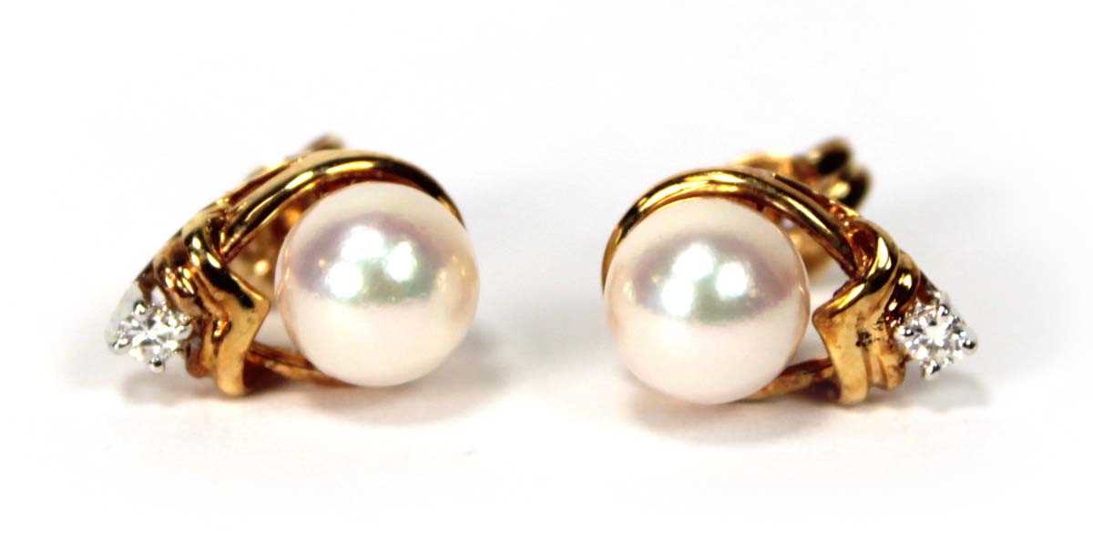 Lot 605 - A pair of 18ct yellow gold ear studs, each set...