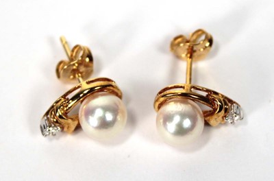 Lot 605 - A pair of 18ct yellow gold ear studs, each set...
