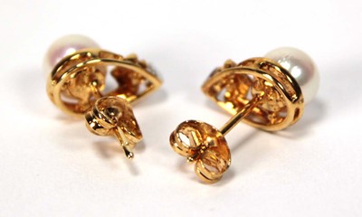 Lot 605 - A pair of 18ct yellow gold ear studs, each set...