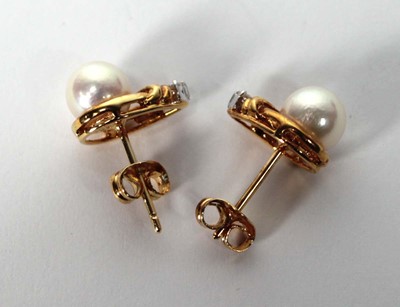 Lot 605 - A pair of 18ct yellow gold ear studs, each set...