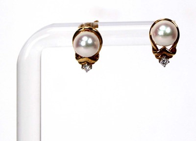 Lot 605 - A pair of 18ct yellow gold ear studs, each set...