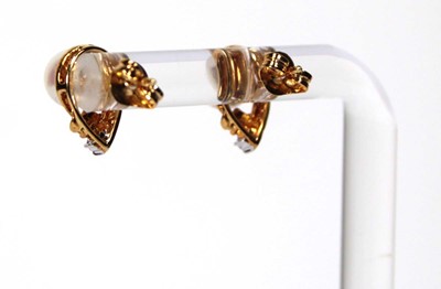 Lot 605 - A pair of 18ct yellow gold ear studs, each set...