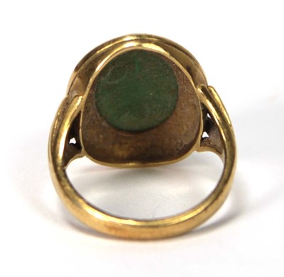 Lot 606 - An 18ct yellow gold ring set cabochon green...